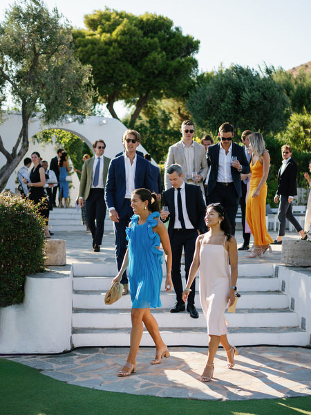 Wedding guests arriving at the ceremony lawn at Island Resort, luxury destination wedding in Athens, Greece.
