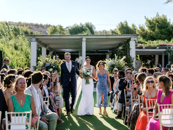 Bride walking down the aisle at Island Resort, elegant Athens Riviera wedding ceremony overlooking the sea.