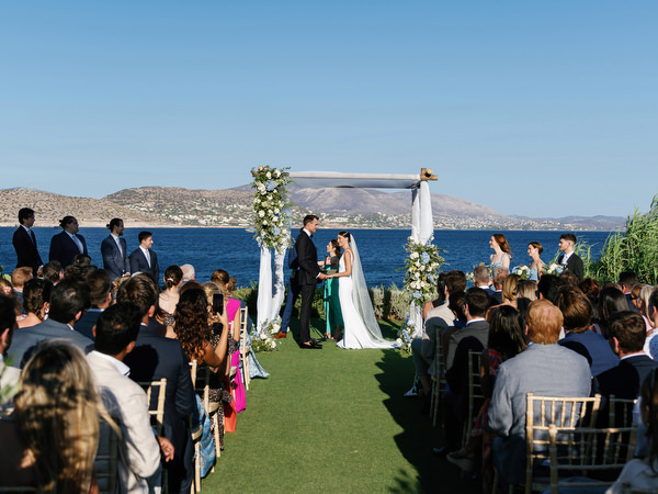 Wide view of seaside ceremony setup at Island Resort, iconic Athens Riviera wedding venue in Greece.