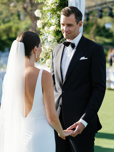 Intimate vow exchange at Island Resort, luxury Athens destination wedding overlooking the sea.