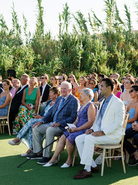 Wedding guests reacting during ceremony at Island Resort, elegant Athens Riviera wedding in Greece.