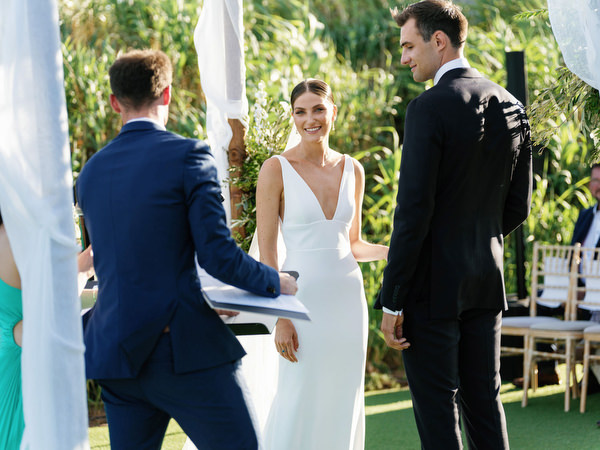 Bride smiling during vows at Island Resort, romantic Athens Riviera seaside wedding in Greece.