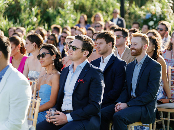 Guests watching ceremony at Island Resort, elegant Athens Riviera wedding celebration.