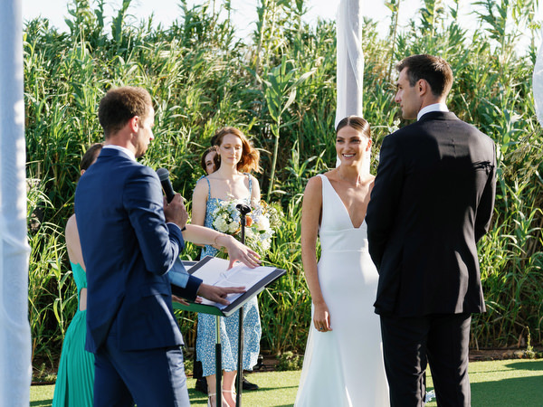 Ceremony moment under chuppah at Island Resort, seaside Athens Riviera Jewish wedding.