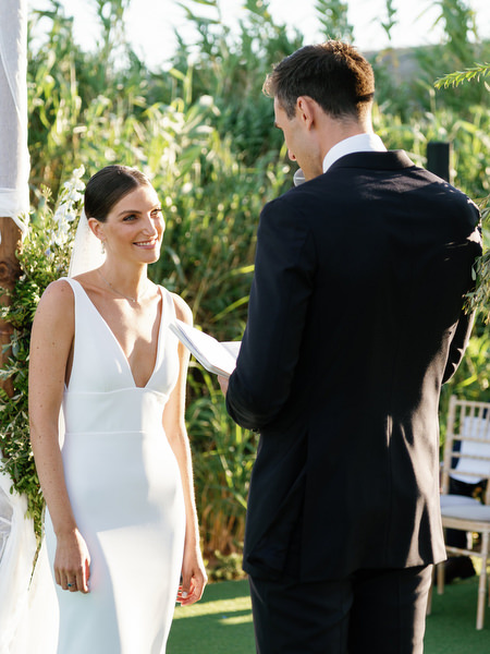 Intimate vow exchange at Island Resort, luxury Jewish wedding in Athens overlooking the sea.