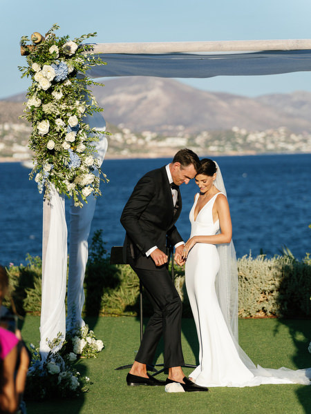Groom stepping on the glass during Jewish wedding ceremony at Island Resort, luxury Athens Riviera destination wedding.