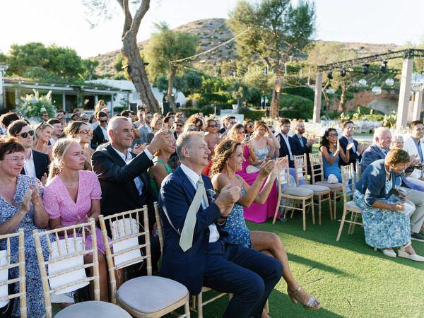 Guests applauding after ceremony at Island Resort, joyful Athens Riviera wedding celebration in Greece.