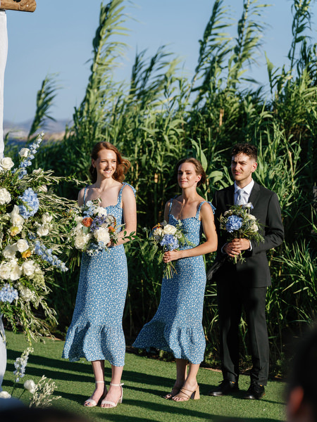 Wedding party holding bouquets at Island Resort, stylish Athens Riviera destination wedding in Greece.