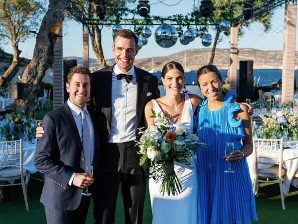Newlyweds with bridesmaids at Island Resort, elegant Athens Riviera destination wedding.