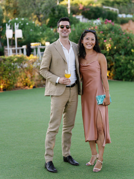 Wedding guests posing during cocktail hour at Island Resort, luxury Athens Riviera wedding reception in Greece.