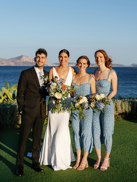 Bride with bridesmaids at Island Resort, chic Athens Riviera destination wedding overlooking the sea.