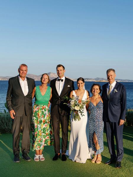 Bride and groom with family at Island Resort, luxury Athens Riviera seaside wedding in Greece.