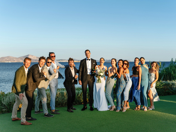Large wedding group portrait at Island Resort, iconic Athens Riviera wedding venue in Greece.