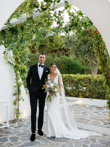 Bride and groom framed by white archways at Island Resort, romantic Athens Riviera wedding photography.