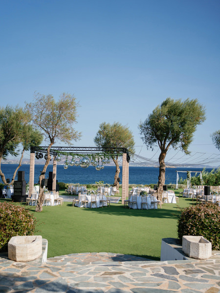 Ocean-view reception lawn at Island Resort, iconic Athens Riviera wedding venue in Greece.