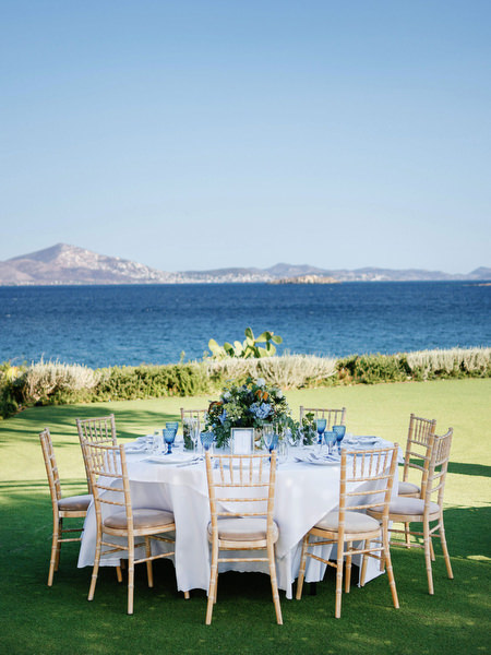 Seaside reception tables at Island Resort, romantic Athens Riviera wedding venue in Greece.
