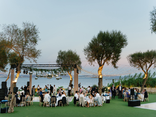 Sunset wedding reception at Island Resort, elegant Athens Riviera celebration by the sea.