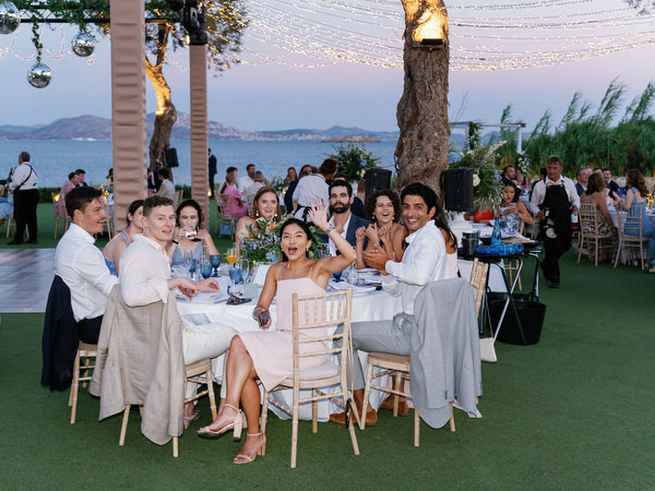 Wedding guests applauding during reception at Island Resort, luxury Athens seaside wedding.