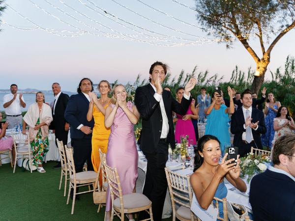 Celebration moment at Island Resort, lively Athens Riviera wedding reception in Greece.