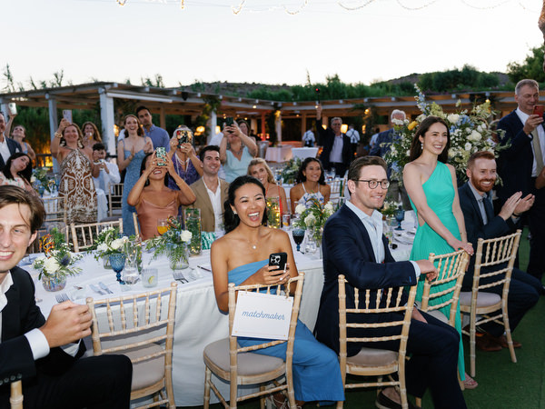 Guests cheering during wedding reception at Island Resort, elegant Athens Riviera destination wedding.