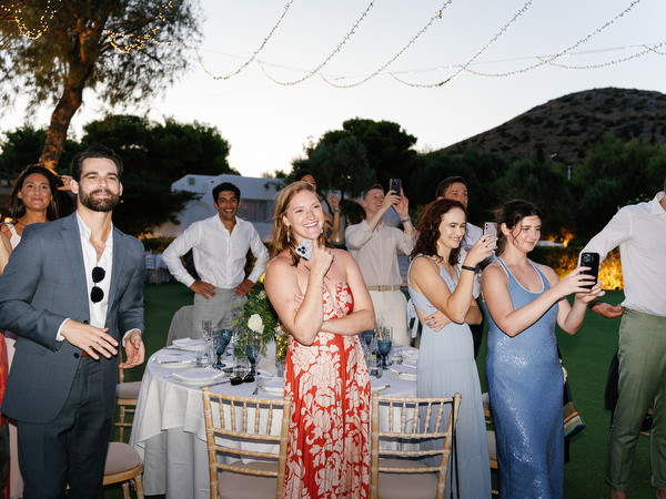 Wedding guests enjoying first dance at Island Resort, stylish Athens Riviera wedding party.