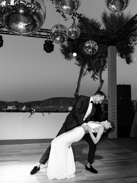 Dramatic black and white first dance at Island Resort, iconic Athens Riviera wedding celebration.