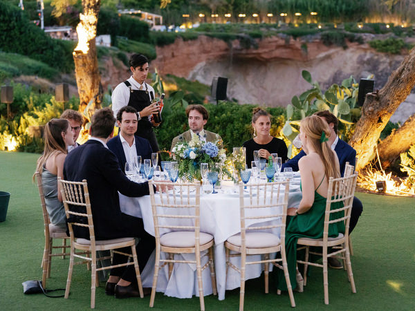 Wedding guests during reception at Island Resort, luxury Athens Riviera seaside wedding.