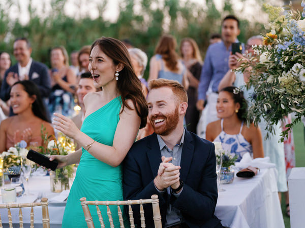 Guests applauding at Island Resort wedding reception, vibrant Athens Riviera celebration.