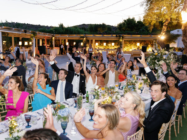 Wedding party celebrating at Island Resort, lively Athens Riviera destination wedding reception.