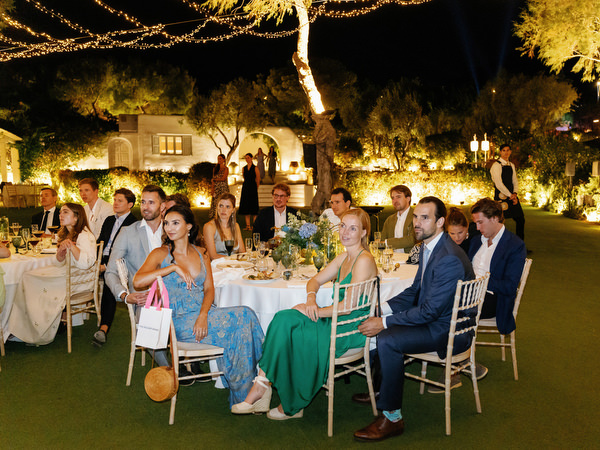 Reception guests enjoying dinner at Island Resort, luxury Athens Riviera destination wedding.