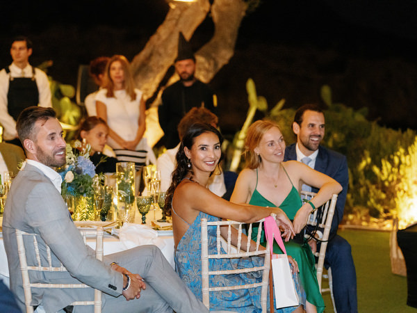 Guests reacting during wedding speech at Island Resort, romantic Athens Riviera reception.