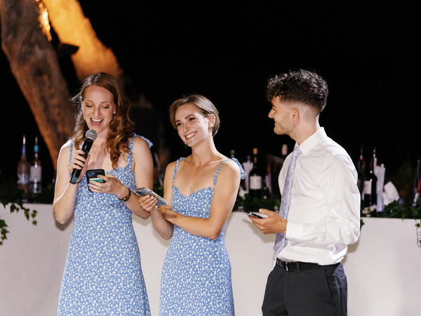 Bridesmaids giving speech at Island Resort wedding reception, Athens Riviera evening celebration.