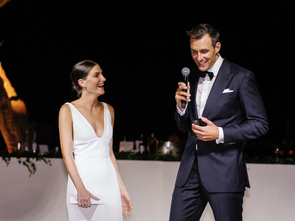 Groom giving speech at Island Resort, luxury Athens Riviera destination wedding reception.