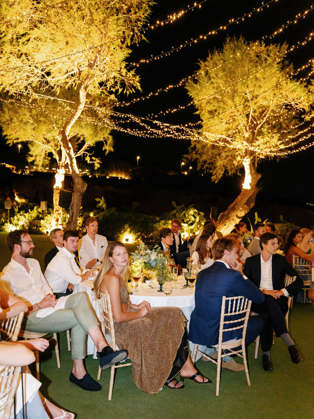Evening wedding reception under olive trees at Island Resort, Athens Riviera destination wedding.