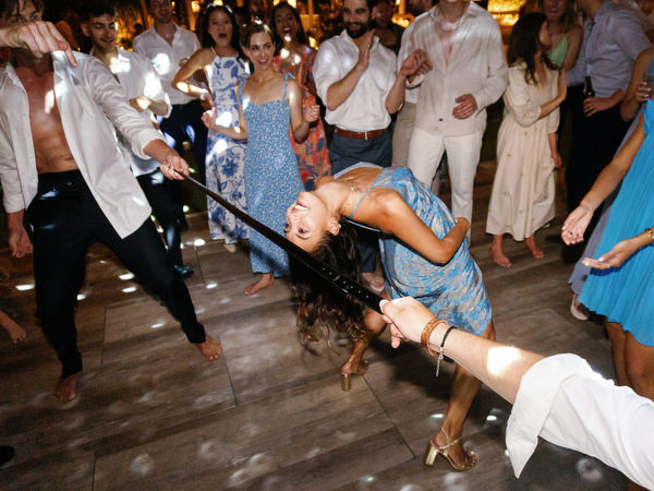 Dance floor fun at Island Resort, high-energy Athens Riviera wedding party at night.