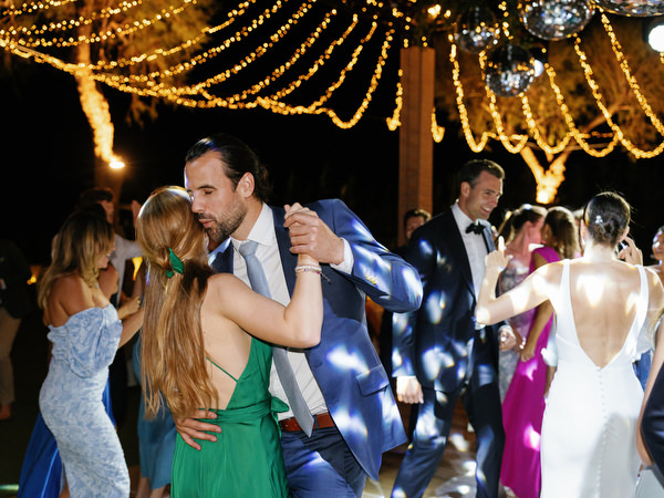 Guests dancing at Island Resort wedding reception, lively Athens Riviera seaside celebration.