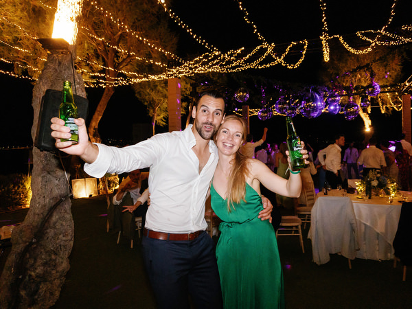 Guests celebrating late-night at Island Resort, lively Athens Riviera seaside wedding reception.