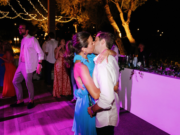 Guests celebrating late-night at Island Resort, lively Athens Riviera seaside wedding reception.