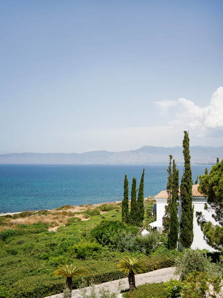 Mediterranean sea view from Anassa Hotel in Cyprus with cypress trees and coastline.