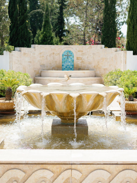 Traditional stone fountain courtyard at Anassa Hotel luxury resort in Cyprus.