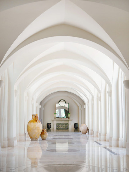 White arched hallway at Anassa Hotel Cyprus Mediterranean luxury resort.