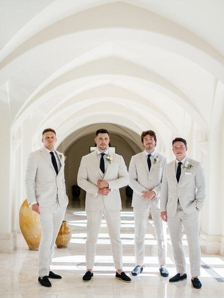 Groom and groomsmen posing at luxury wedding venue Anassa Hotel in Cyprus.