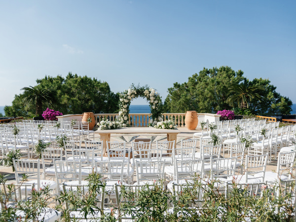 Outdoor wedding ceremony setup overlooking the sea at Anassa Hotel Cyprus.