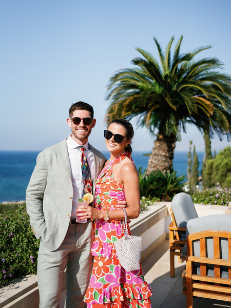 Wedding guests posing with Mediterranean sea view at Anassa Hotel Cyprus.