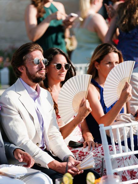 Wedding guests seated at outdoor ceremony at Anassa Hotel Cyprus.