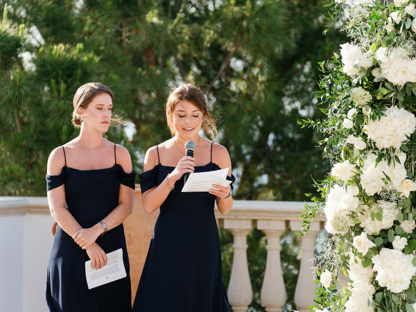 Bridesmaids giving reading during luxury outdoor wedding ceremony in Cyprus.