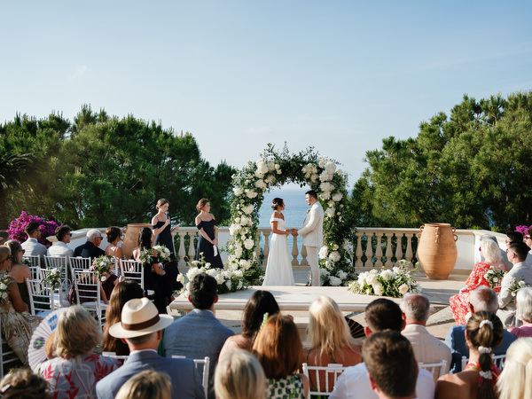 Bride and groom exchanging rings during ceremony at Anassa Hotel Cyprus.