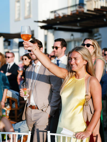 Wedding guests toasting during luxury destination wedding in Cyprus.