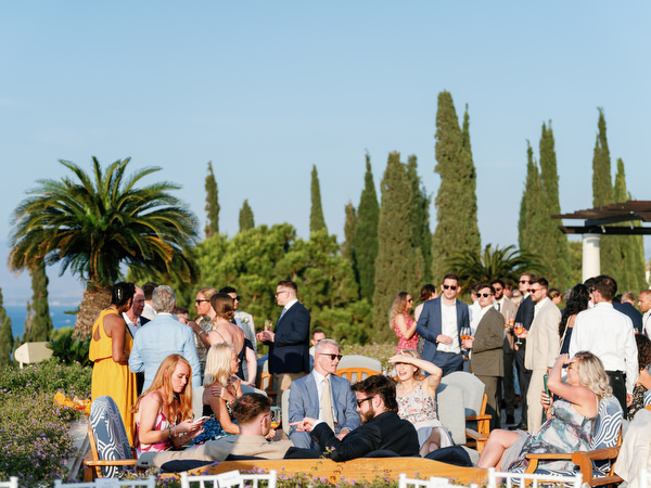 Guests mingling during cocktail hour at luxury Cyprus destination wedding.