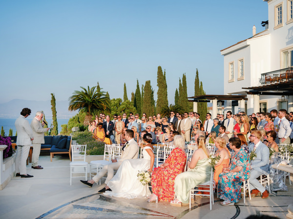 Guests enjoying sunset drinks at Anassa Hotel coastal wedding in Cyprus.